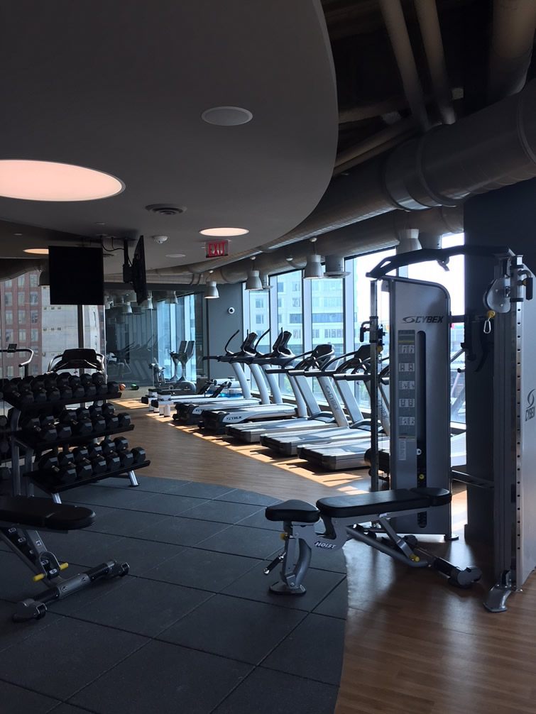 our clean, modern fitness center with weight lifting equipment and treadmills